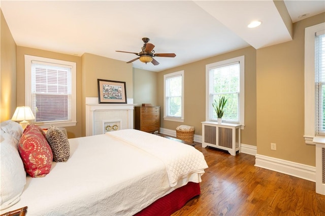 6020 Grafton St, Highland Park, PA 15206 - bedroom featuring radiator heating unit, wood finished floors, and ceiling fan