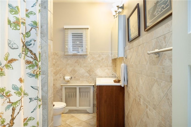 6020 Grafton St, Highland Park, PA 15206 - bathroom with tile walls, radiator, vanity, tile patterned floors, and a wainscoted wall