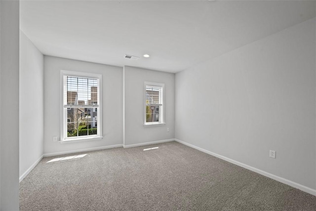 empty room with carpet, baseboards, and recessed lighting