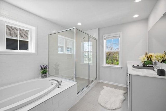 full bath with a garden tub, a shower stall, double vanity, and recessed lighting