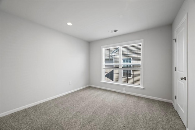 empty room featuring carpet flooring, baseboards, and recessed lighting