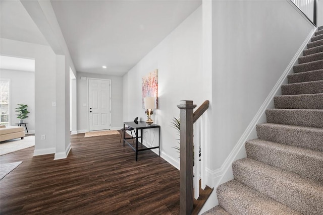 stairs with wood finished floors, baseboards, and recessed lighting