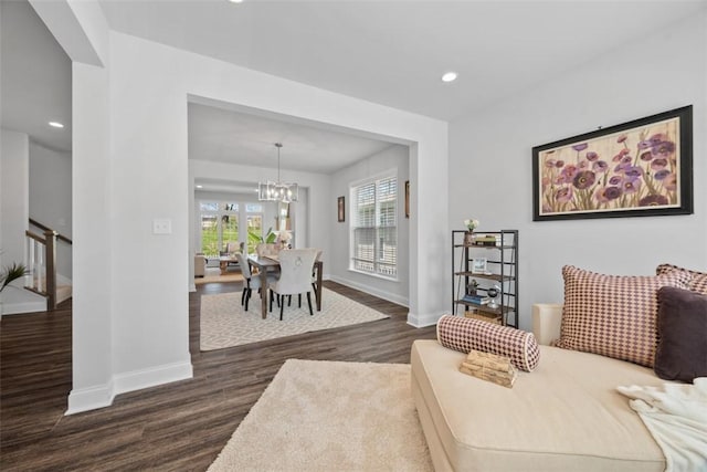 living area with dark wood-type flooring, baseboards, a chandelier, and recessed lighting