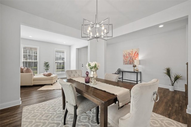 dining area featuring a chandelier, wood finished floors, baseboards, and recessed lighting