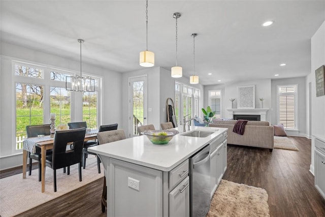 kitchen with dishwasher, a sink, plenty of natural light, light countertops, and recessed lighting