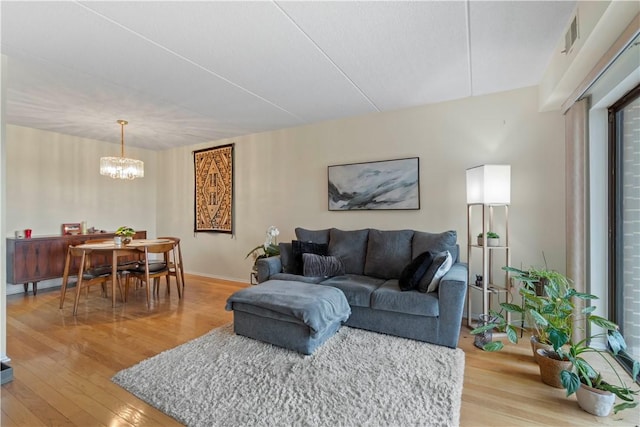 5600 Munhall Rd Unit 517, Squirrel Hill, PA 15217 - living room featuring light wood-type flooring, a chandelier, baseboards, and plenty of natural light