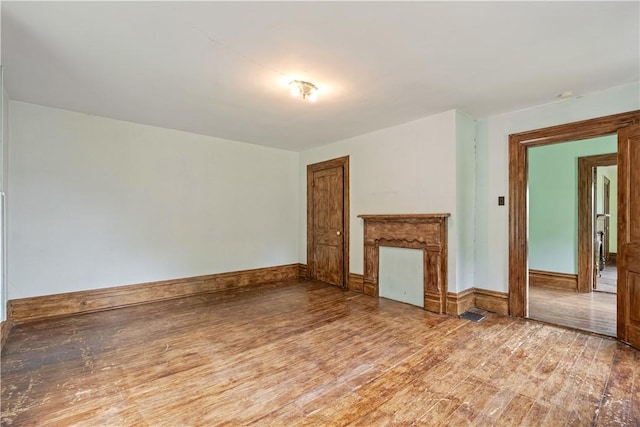 unfurnished living room featuring light wood-style flooring