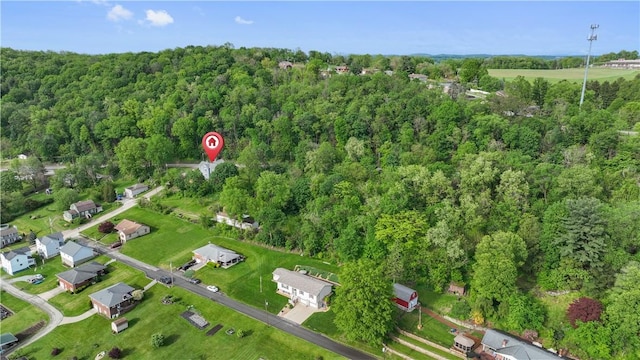 aerial view of property's location with a forest