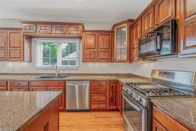 2108 Beams Run Rd, Jefferson Hills, PA 15025 - kitchen featuring appliances with stainless steel finishes, a sink, light wood-type flooring, glass insert cabinets, and brown cabinetry
