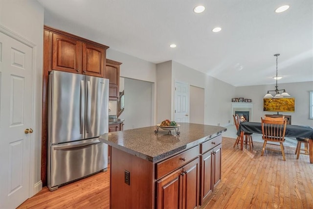 2108 Beams Run Rd, Jefferson Hills, PA 15025 - kitchen featuring freestanding refrigerator, a glass covered fireplace, light wood-style flooring, a kitchen island, and open floor plan