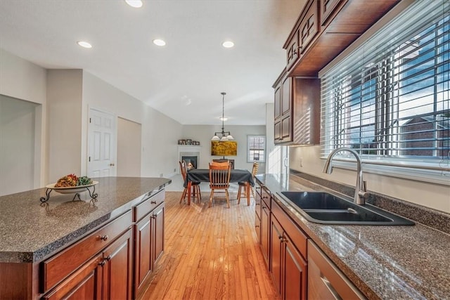2108 Beams Run Rd, Jefferson Hills, PA 15025 - kitchen with a sink, light wood-style floors, recessed lighting, a glass covered fireplace, and pendant lighting