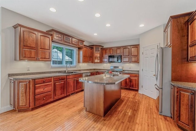 2108 Beams Run Rd, Jefferson Hills, PA 15025 - kitchen featuring appliances with stainless steel finishes, a sink, a center island, light wood-style flooring, and brown cabinetry