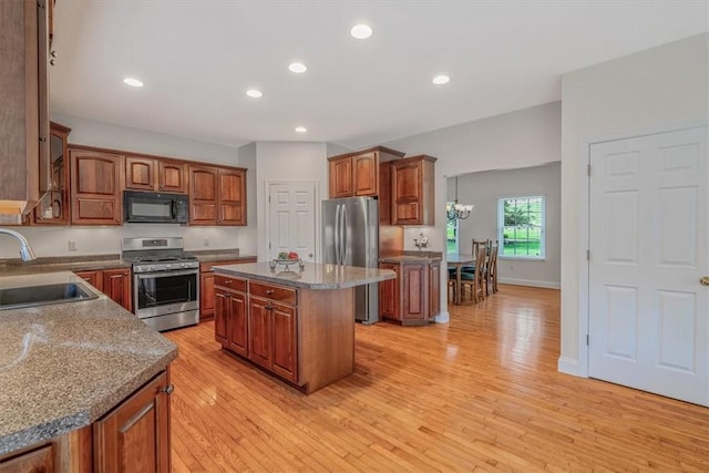 2108 Beams Run Rd, Jefferson Hills, PA 15025 - kitchen with appliances with stainless steel finishes, a sink, light wood finished floors, a kitchen island, and brown cabinetry