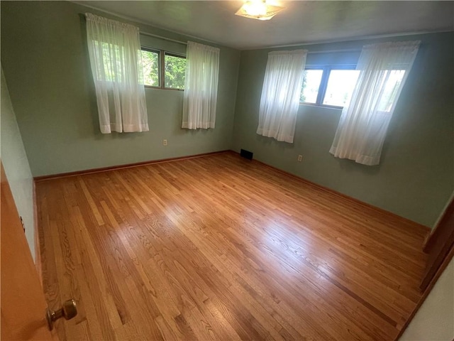 107 Pfaff Rd, Economy, PA 15005 - empty room featuring plenty of natural light, wood finished floors, and baseboards