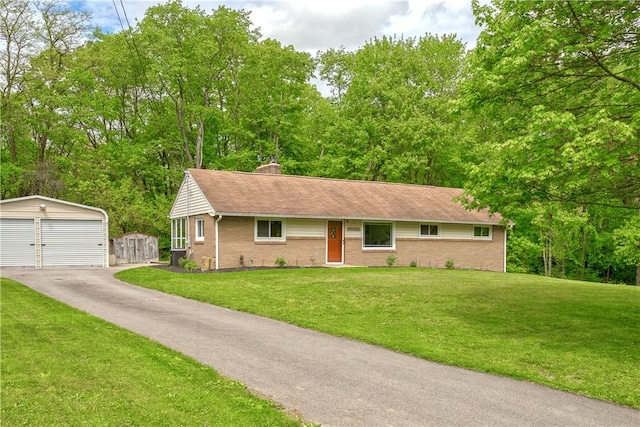ranch-style home with an outdoor structure, brick siding, a detached garage, and a front lawn