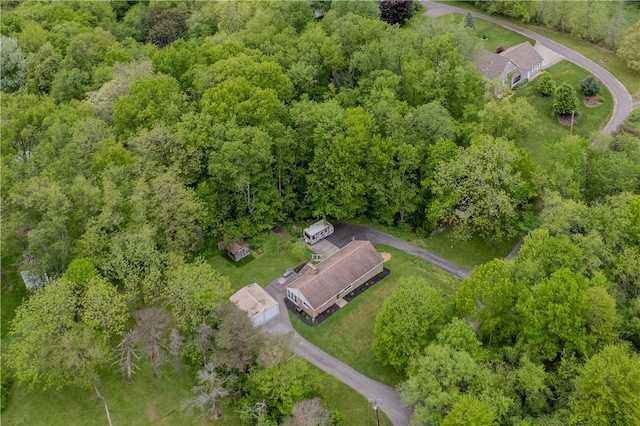 view of property location with a forest