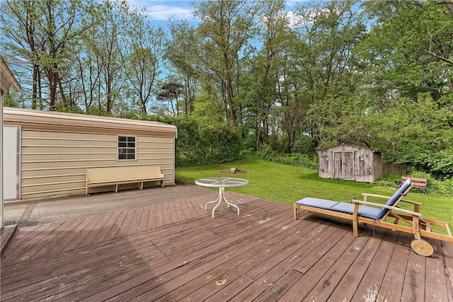 wooden deck featuring an outdoor structure, a shed, and a lawn