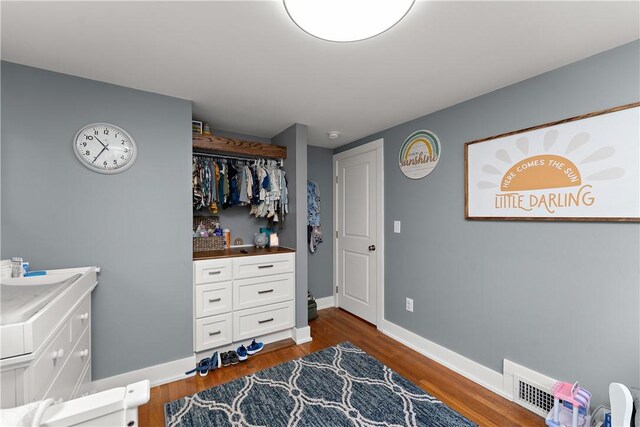 bedroom featuring dark wood finished floors and baseboards