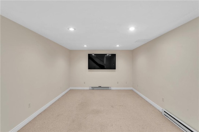 spare room with a baseboard heating unit, a baseboard radiator, light carpet, baseboards, and recessed lighting