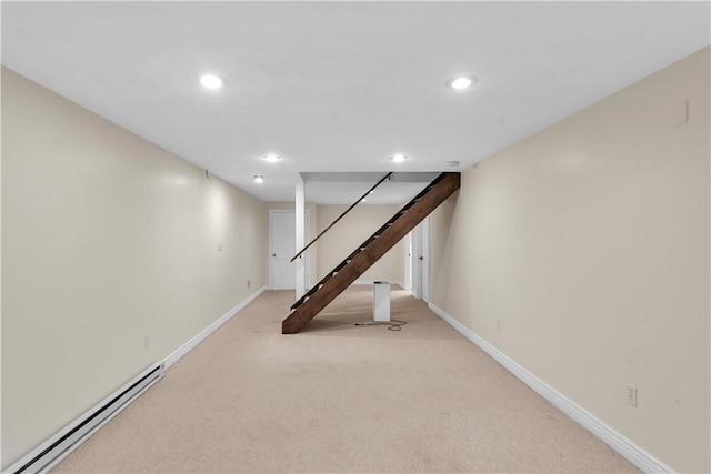 finished basement featuring a baseboard radiator, carpet flooring, baseboards, recessed lighting, and stairs