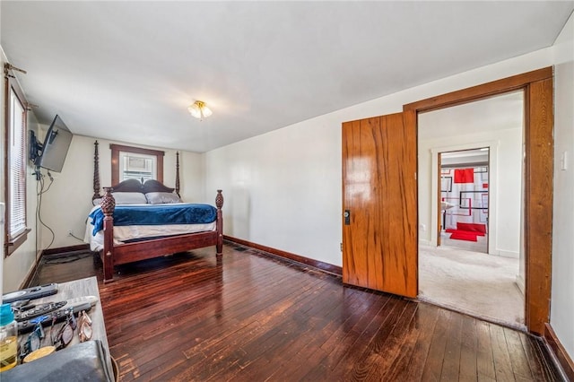 bedroom with dark wood-style flooring and baseboards