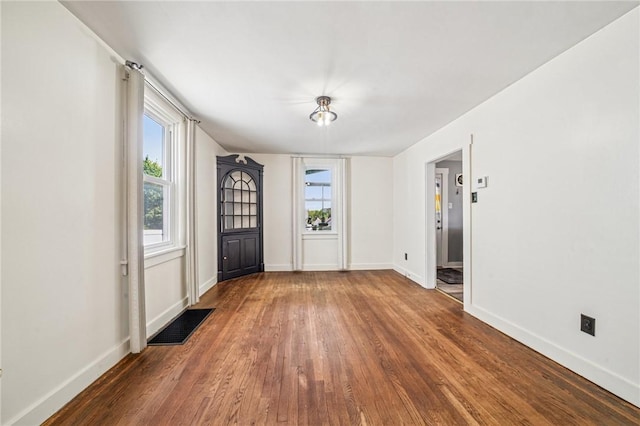 entrance foyer featuring wood finished floors and baseboards