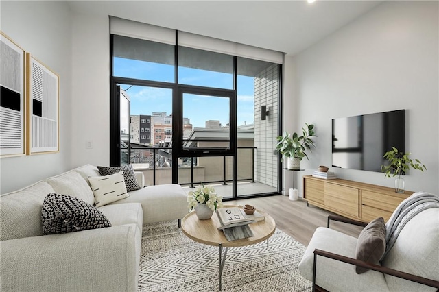 living room with floor to ceiling windows and wood finished floors