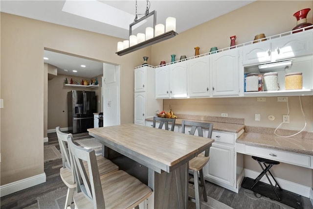 120 Dravo Ave, Beaver, PA 15009 - kitchen with black refrigerator with ice dispenser, baseboards, white cabinets, and dark wood finished floors