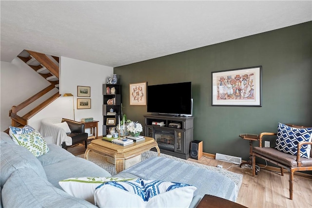 living area with wood finished floors and baseboards