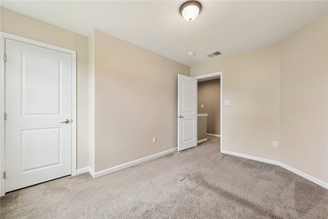 unfurnished bedroom featuring carpet floors and baseboards