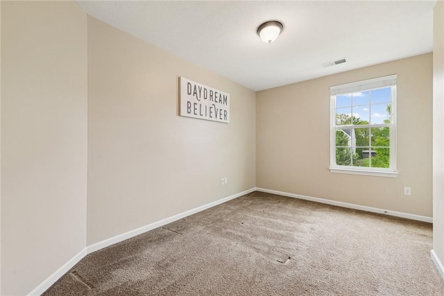 unfurnished room with carpet flooring and baseboards