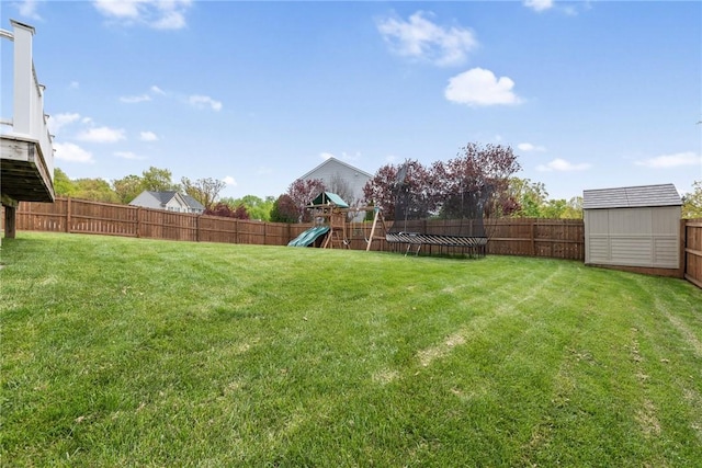 view of yard with a playground and a shed