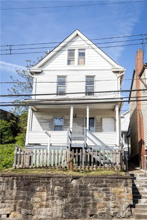 view of front of house with stairs and covered porch