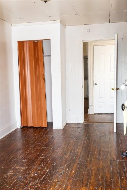 spare room with hardwood / wood-style flooring and baseboards