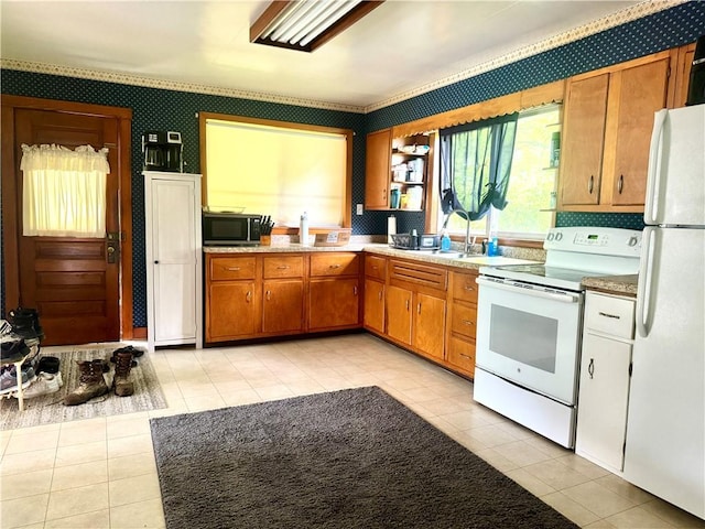 kitchen with white appliances, wallpapered walls, light tile patterned flooring, light countertops, and brown cabinets