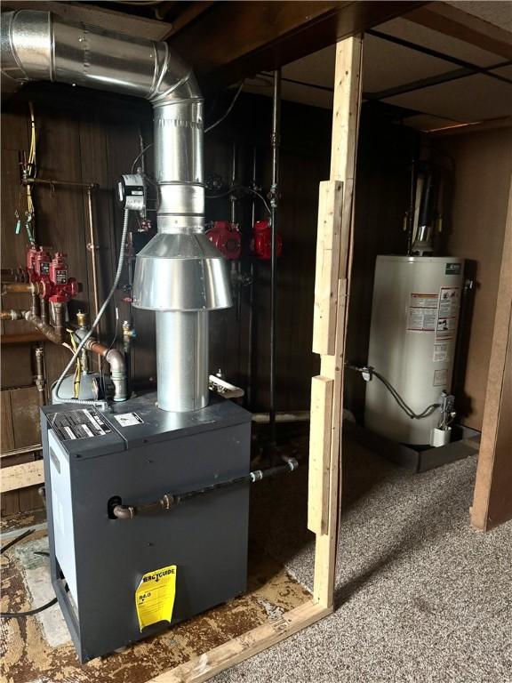 utility room with gas water heater and a heating unit