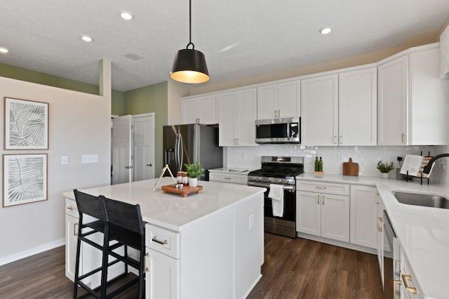 422 Hawthorn Hill Dr, Canonsburg, PA 15317 - kitchen with stainless steel appliances, decorative backsplash, white cabinets, a center island, and dark wood-type flooring