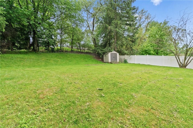 view of yard featuring a shed and an outbuilding