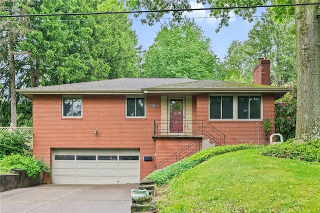 view of front of house featuring an attached garage, brick siding, a chimney, driveway, and a front yard