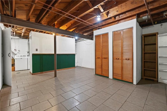 basement featuring washer / dryer and tile patterned floors