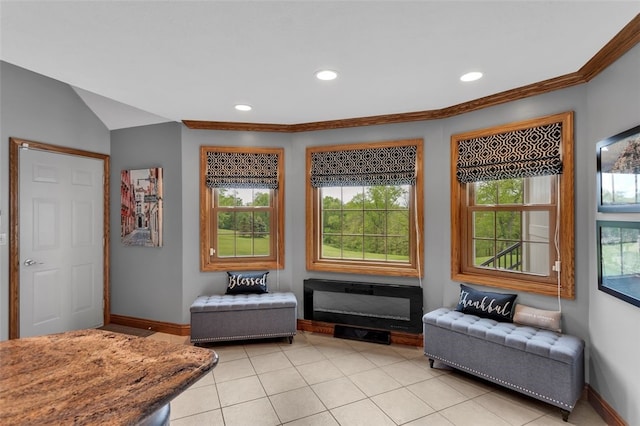 living area with baseboards, healthy amount of natural light, recessed lighting, and crown molding