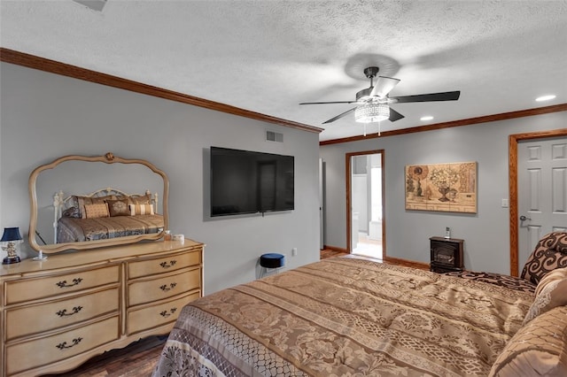 bedroom with dark wood finished floors, crown molding, a textured ceiling, a ceiling fan, and connected bathroom