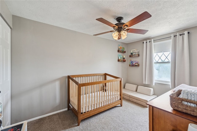 112 Cranbrooke Dr, Findlay Twp, PA 15108 - carpeted bedroom featuring a textured ceiling, a ceiling fan, baseboards, and a nursery area