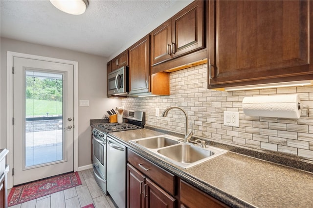 112 Cranbrooke Dr, Findlay Twp, PA 15108 - kitchen with appliances with stainless steel finishes, a sink, dark countertops, tasteful backsplash, and a textured ceiling