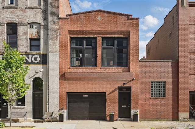 view of property with an attached garage and driveway