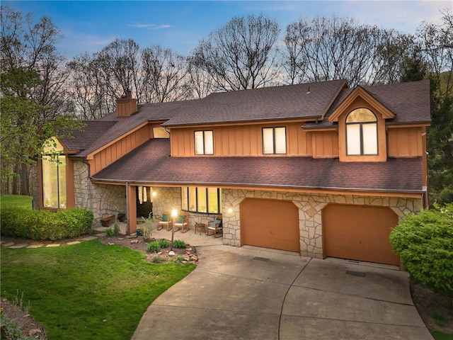 4616 Windbrook, Murrysville, PA 15668 - view of front of home with board and batten siding, stone siding, driveway, and a garage