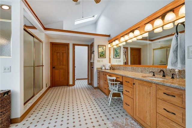 4616 Windbrook, Murrysville, PA 15668 - bathroom featuring a shower stall, a skylight, double vanity, vaulted ceiling, and tile patterned floors