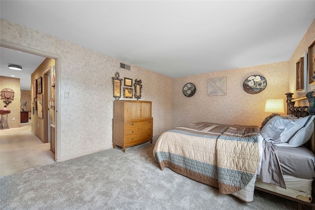 bedroom with carpet and wallpapered walls