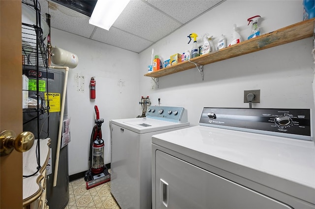 laundry room featuring washing machine and clothes dryer and water heater