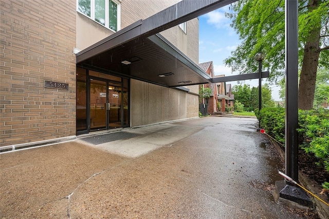 view of exterior entry with brick siding